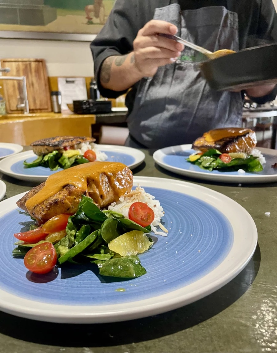 Chef serving individual plates during a private Cabo dinner